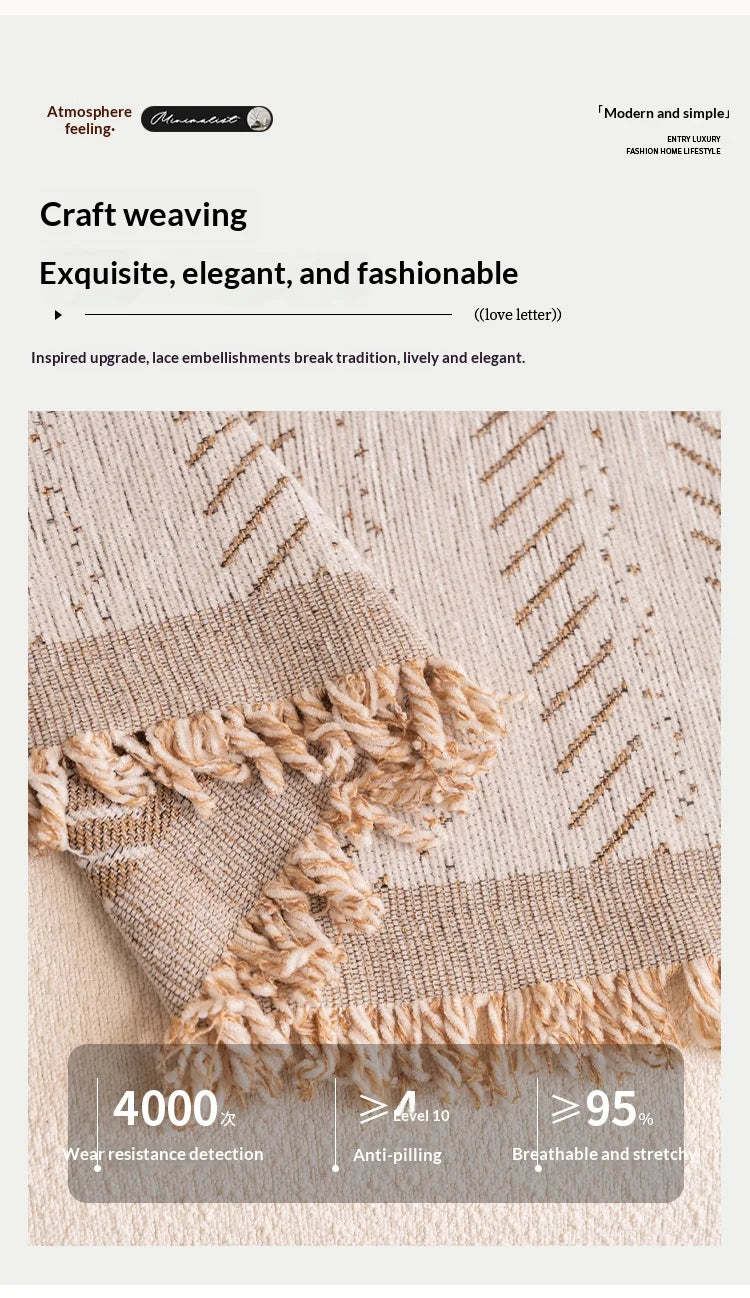 Close-up of a beige textile fabric showing a woven texture and a fringed edge.