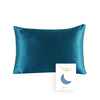 A deep teal silk pillowcase with a crescent moon design.