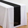 Elegant satin black table runner draped across a white tablecloth.
