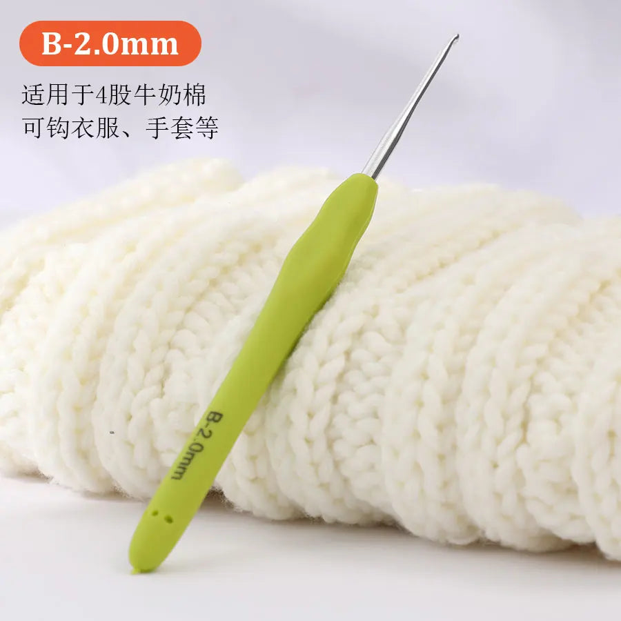 A yellow B-2.0mm crochet hook is shown next to a ball of white yarn.