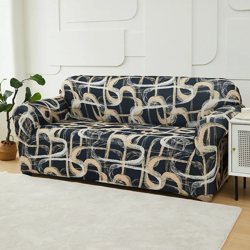 A navy blue and beige patterned stretch sofa slipcover displayed on a light rug against a white wall.