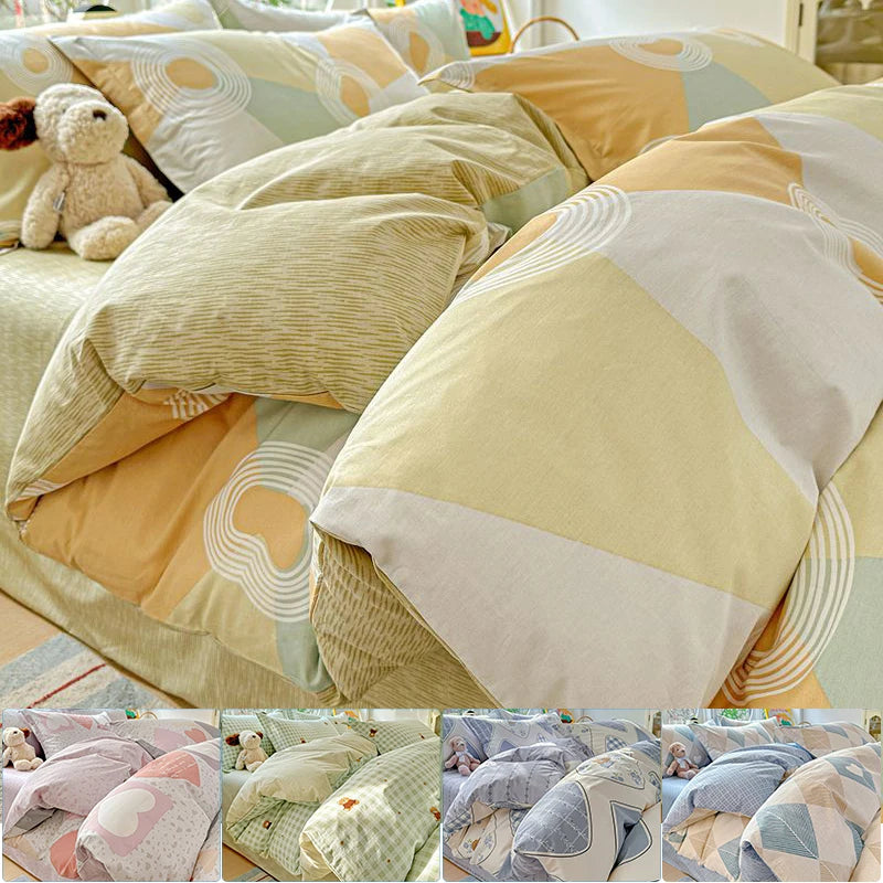 A close-up of a beige and olive green cotton duvet and pillow set featuring geometric patterns.