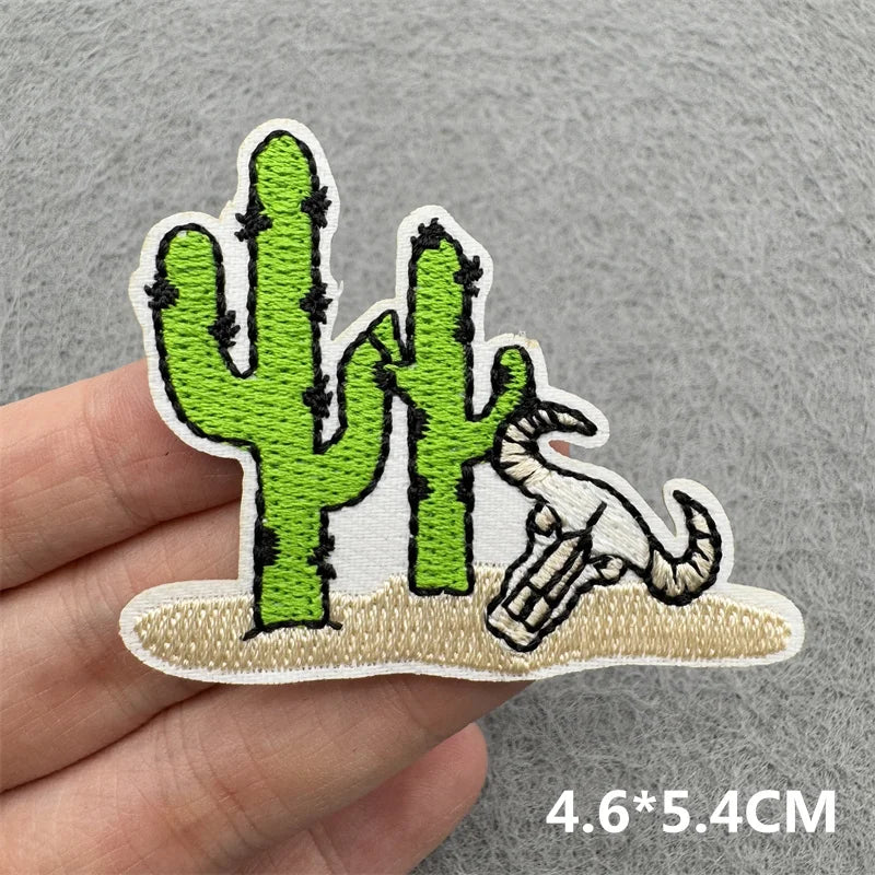Embroidered patch featuring a cactus and a lizard on a beige background