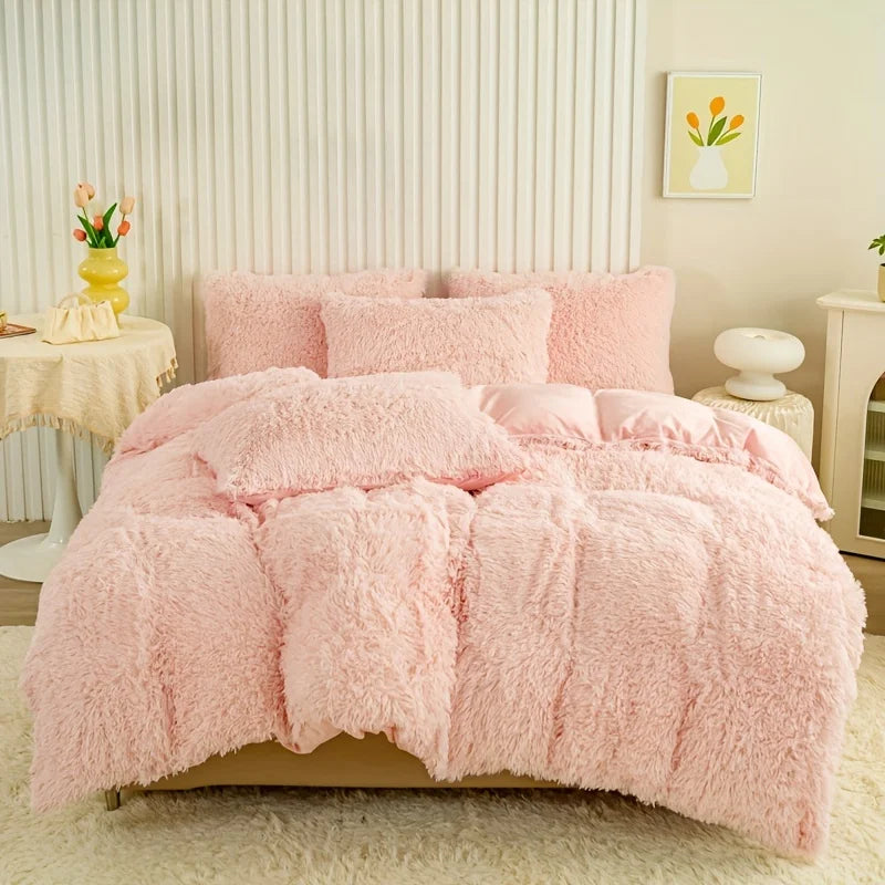 A fluffy pink plush duvet cover set displayed on a bed against a white paneled wall.