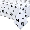 White disposable plastic tablecloth patterned with black paw prints