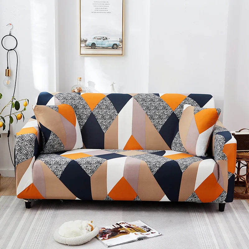 A modern sofa covered in a geometric pattern featuring shades of gray, black, orange, and beige.