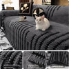 A dark gray bohemian striped sofa cover featuring textured knit fabric and decorative pillows with a white cat.