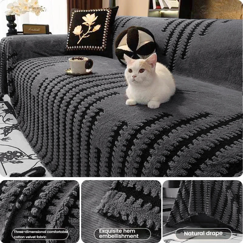 A dark gray bohemian striped sofa cover featuring textured knit fabric and decorative pillows with a white cat.