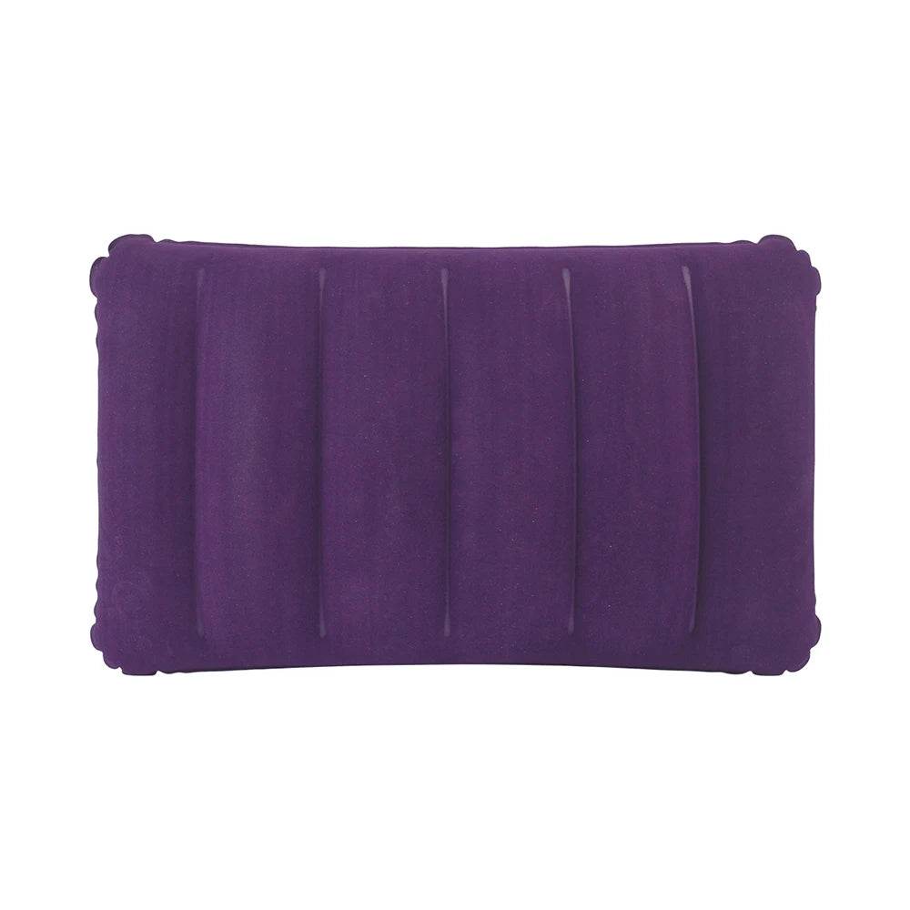 A purple portable inflatable travel pillow with ribbed texture.