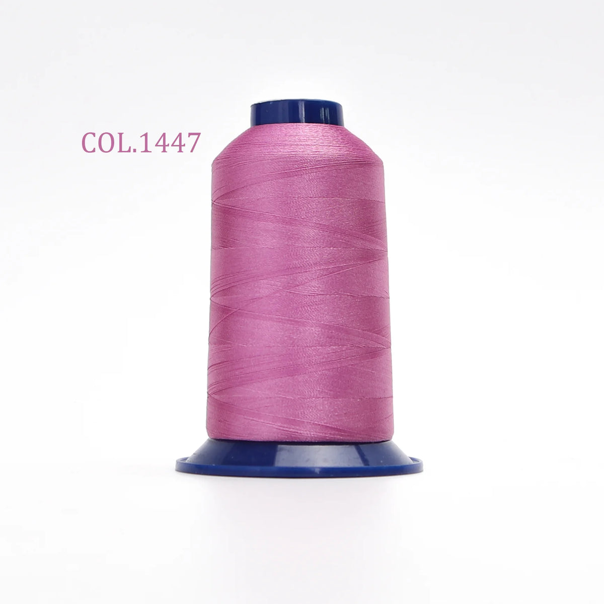 A spool of magenta polyester embroidery thread labeled COL.1447