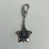 Silver chain keychain featuring a star-shaped pocket watch with a black face and silver hands.