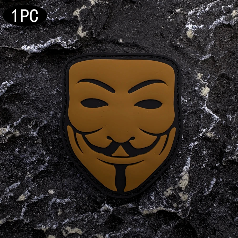 A single embroidered patch featuring a black smiley face design on an orange background with a black border.