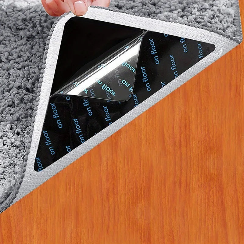 A close-up of reusable non-slip rug grippers, featuring a clear plastic sheet with text on the bottom, placed on a wooden sur
