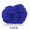 A ball of deep blue hand-woven chunky chenille yarn.