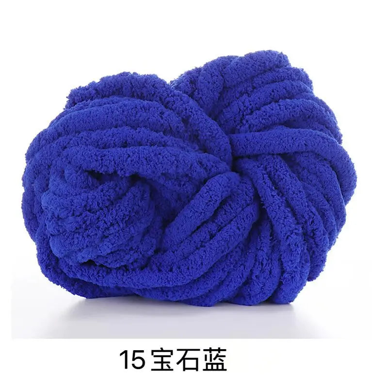 A ball of deep blue hand-woven chunky chenille yarn.