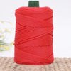 A skein of bright red 3mm ice rope crochet yarn is shown on a woven surface.