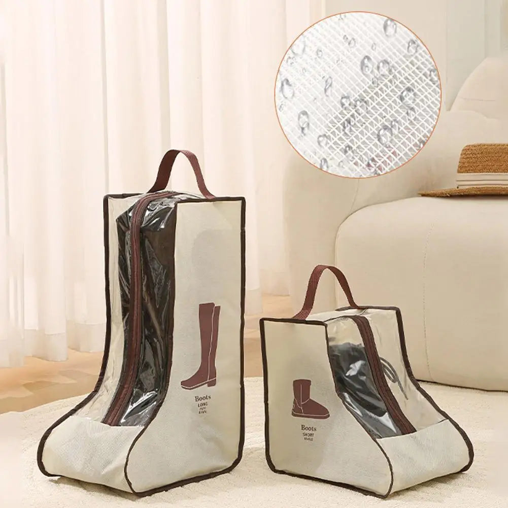 A pair of beige boot storage bags with clear windows and carry handles resting on a light-colored surface.