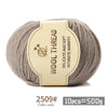 A ball of gray wool thread with a label indicating it is delicate and soft intimate warmth.