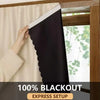 A hand is installing a black blackout window curtain in a wooden frame next to a sheer white drape.