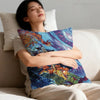 A person rests their head on a white pillow while holding an anime style monster print pillow cover.