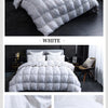 White quilted luxury goose down duvet blanket displayed on a bed.