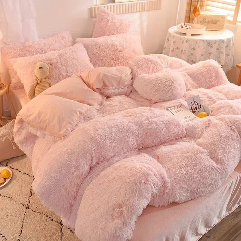 A pink plush mink velvet duvet set with fluffy pink bedding and pillows on a bed.