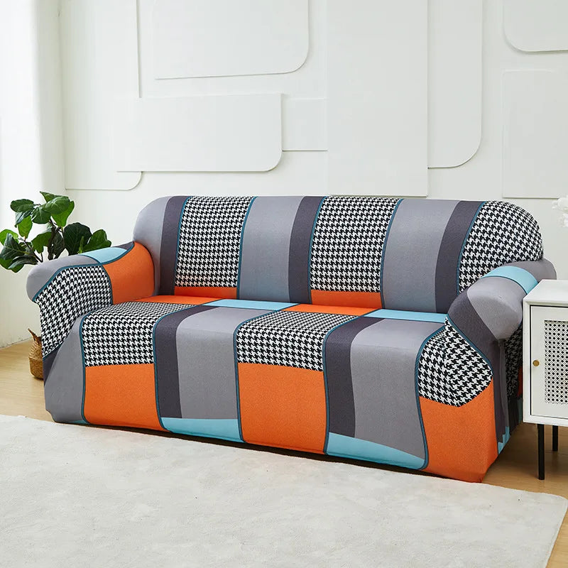A modern sofa and chair slipcover featuring a patchwork design in gray, orange, blue, and black checkered patterns.
