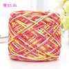 A ball of pink and yellow metallic silk yarn used for crocheting and knitting