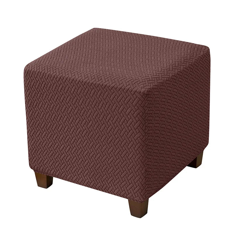 A square ottoman slipcover in a deep reddish-brown jacquard fabric with a textured pattern.