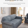 A gray stretch knit sofa cover featuring a bubble lattice texture displayed in a living room setting.