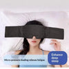 A woman is wearing a black micro-pressure shading sleep mask while lying in bed.