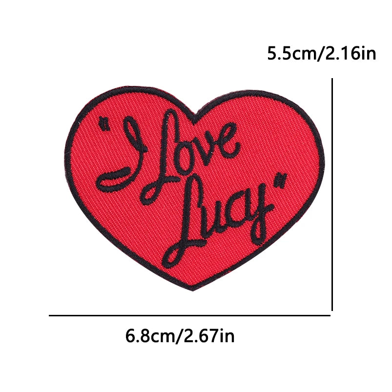 Red heart shaped embroidery patch with the text I Love Lucy embroidered in black script