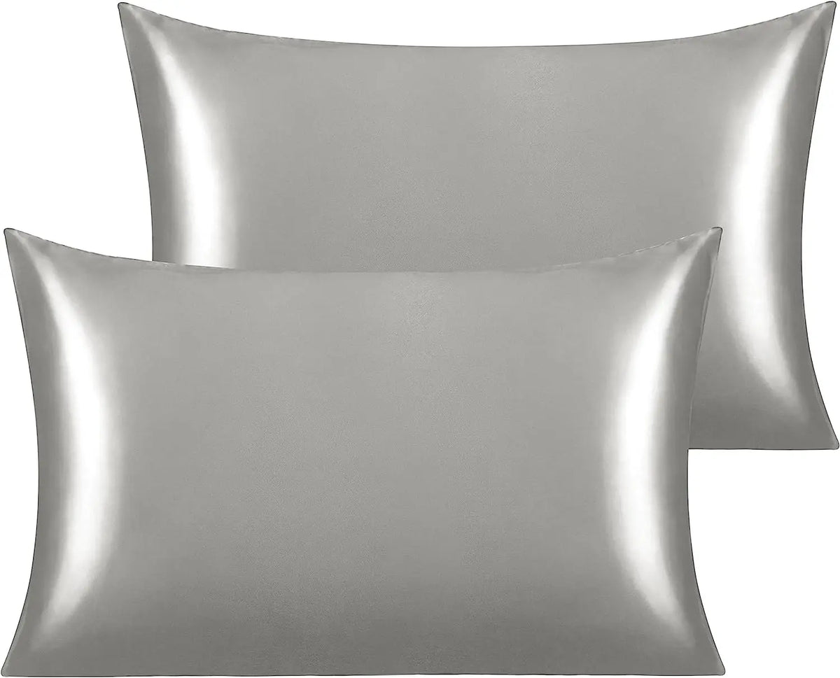 A pair of silky satin toddler pillowcases in a silver-gray color.