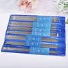 A set of blue plastic packaging containing various stainless steel knitting needles with different sizes and lengths.