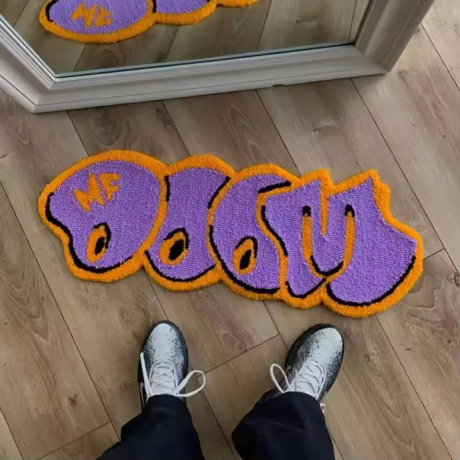Purple and orange cartoon decorative floor mat with the text MF DOOM