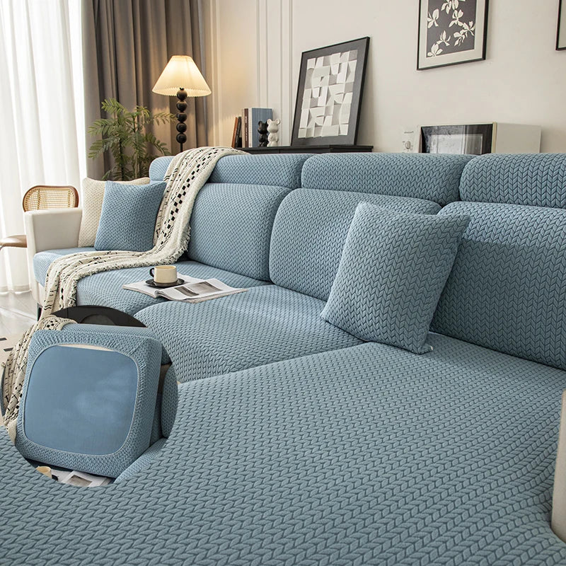 A light blue plush elastic sofa cushion cover displayed on a modern sofa with neutral decor.