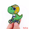 Embroidered patch of a green cartoon dinosaur character with yellow accents and bicycle details