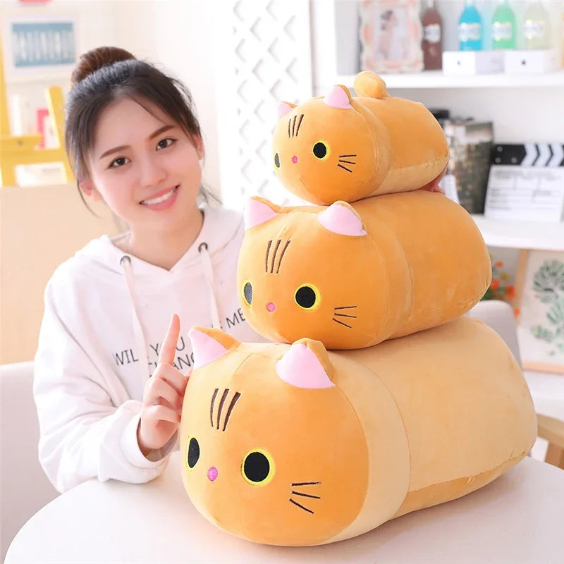 A stack of soft, yellow cat plush pillows or cushions in various sizes.