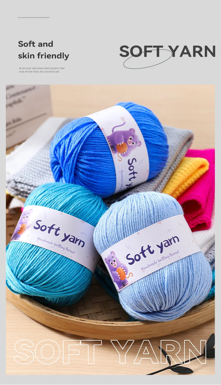 A collection of soft yarn in blue and teal colors is displayed on a wooden surface.