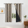 A pair of beige blackout curtains with a golden wave pattern hanging on a rod.