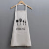 A white waterproof oil-proof PVC kitchen apron with a pocket and the word COOKING printed on it.