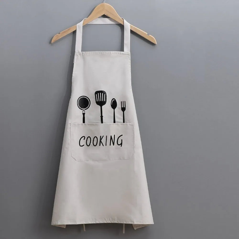 A white waterproof oil-proof PVC kitchen apron with a pocket and the word COOKING printed on it.