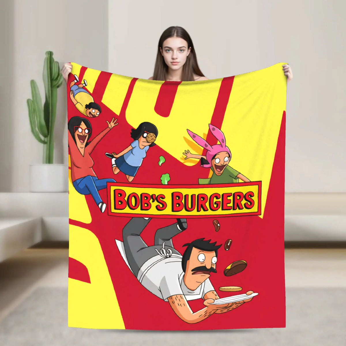A colorful throw blanket featuring cartoon characters and text promoting Bob's Burgers.