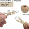 A hand holds a wooden clothespin with jute twine, next to a ball of natural fiber twine.