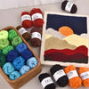 A collection of 12-color soft acrylic yarn skeins and a knitted landscape display.