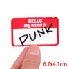 A red and white embroidery patch with the word PUNK embroidered in black script.