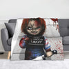 A plush blanket featuring a graphic of Chucky the doll with blood splatter and a distressed expression.