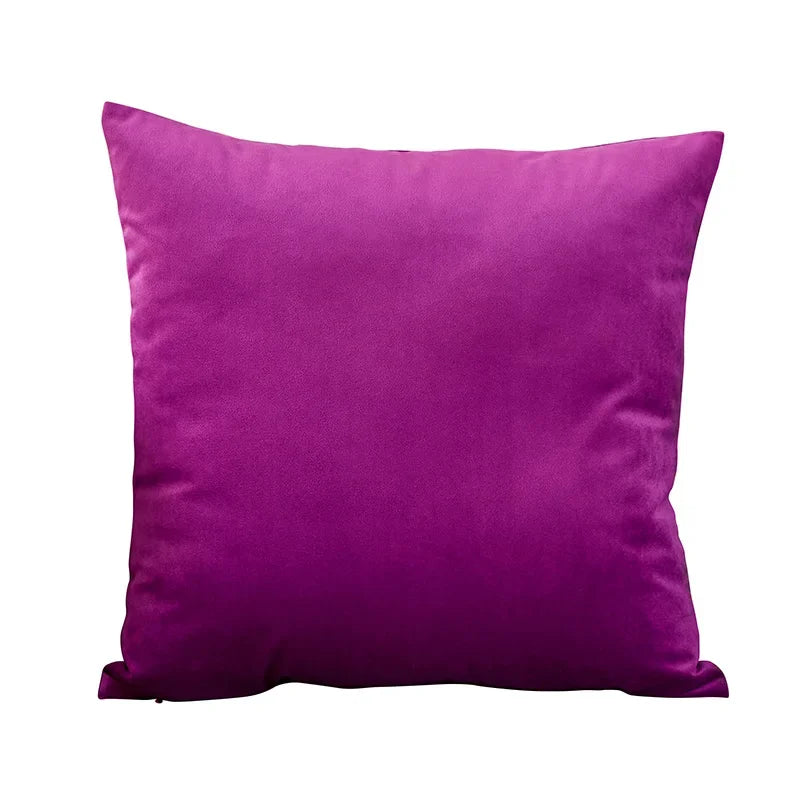 A square velvet throw pillow cover in a deep magenta color.