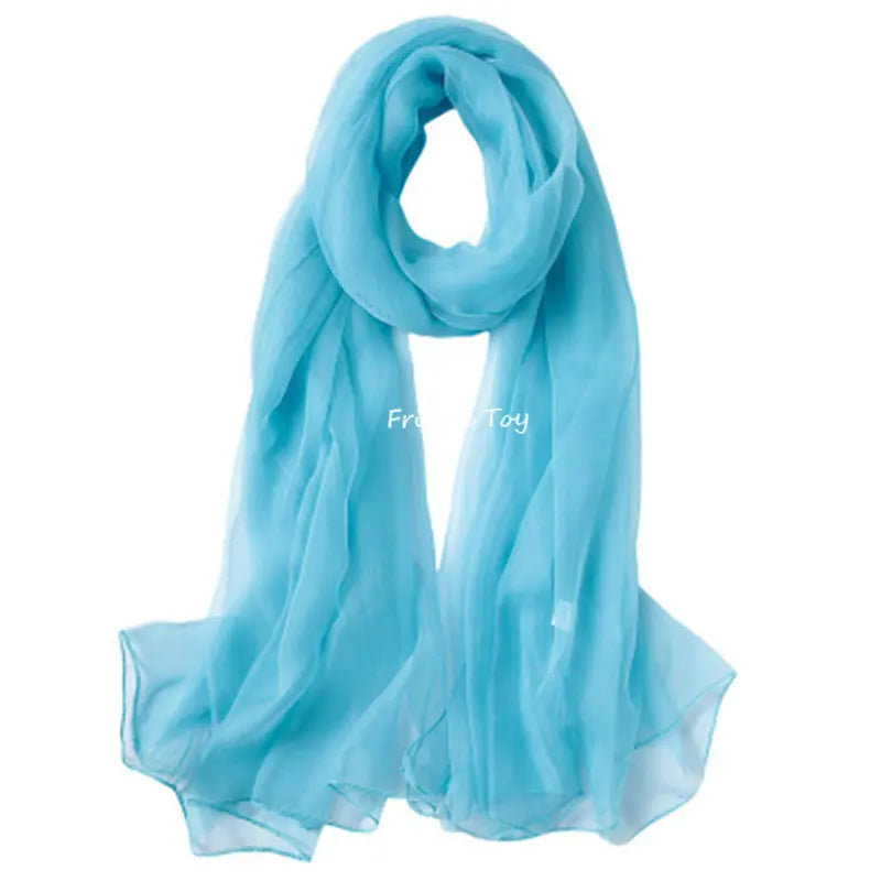 Light blue sheer scarf draped and folded for a toddler's sensory play