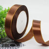 Roll of brown satin ribbon with gold edge for gift wrapping and crafts